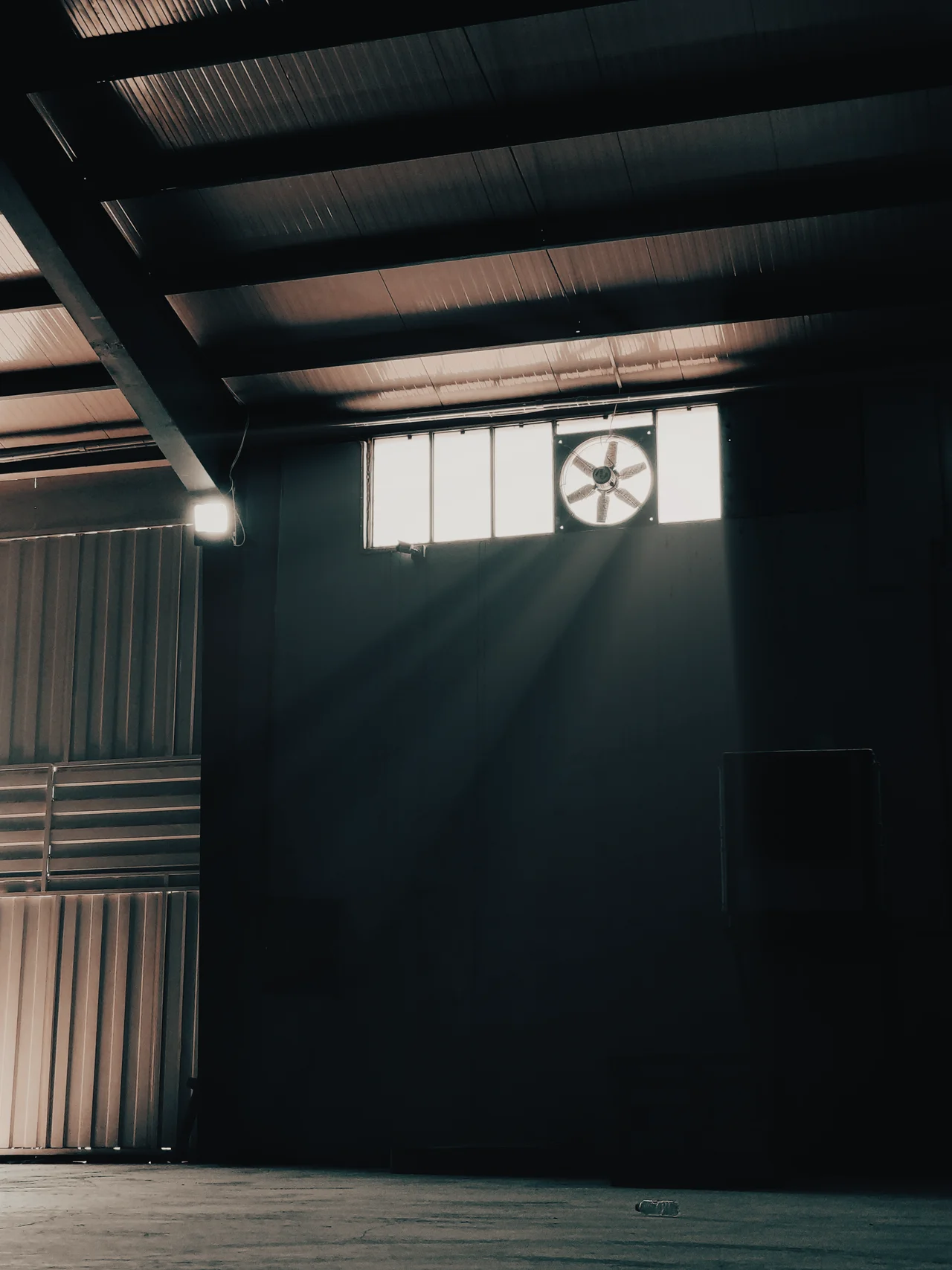Industrial exhaust fan in a warehouse facility